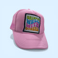 Pink cap with a colorful patch on a light blue background