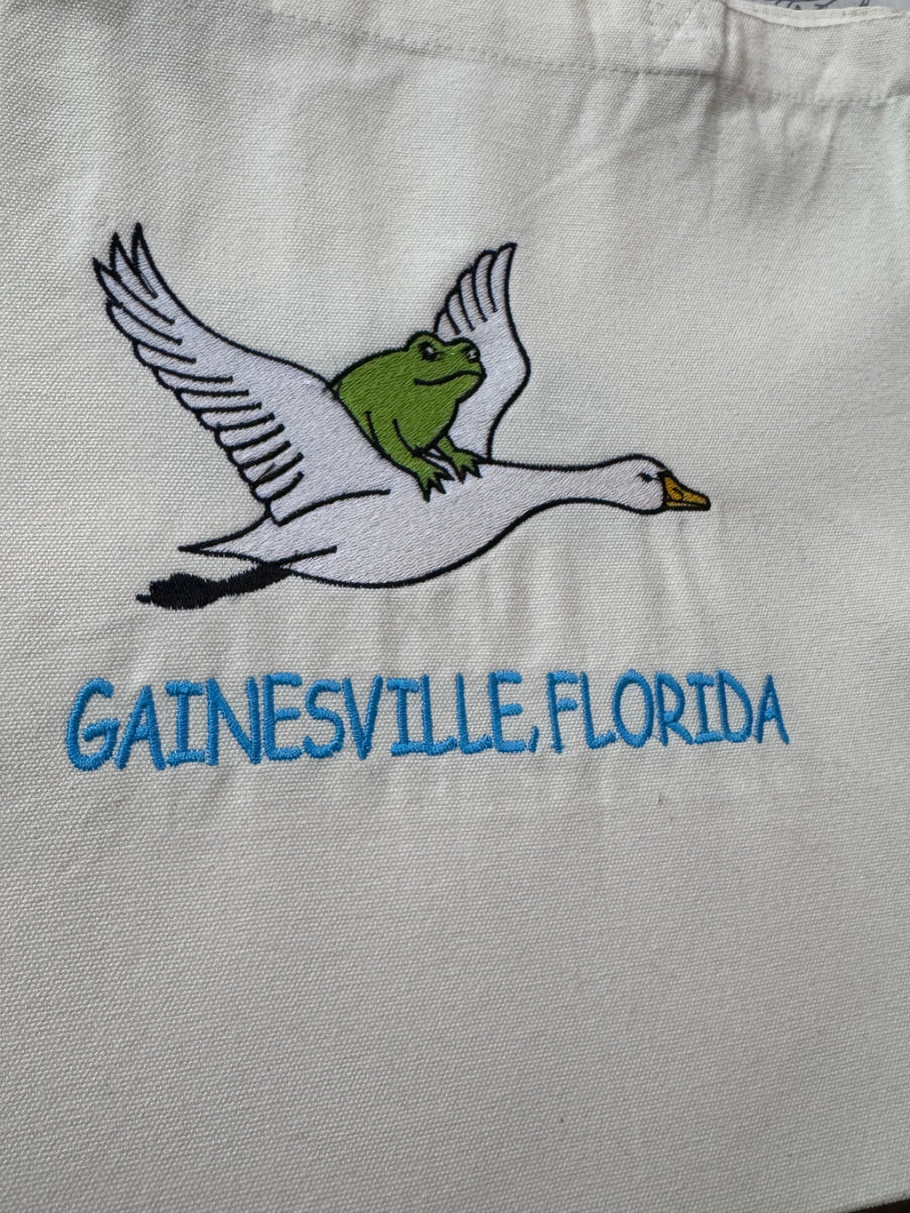 Frog riding on a goose.