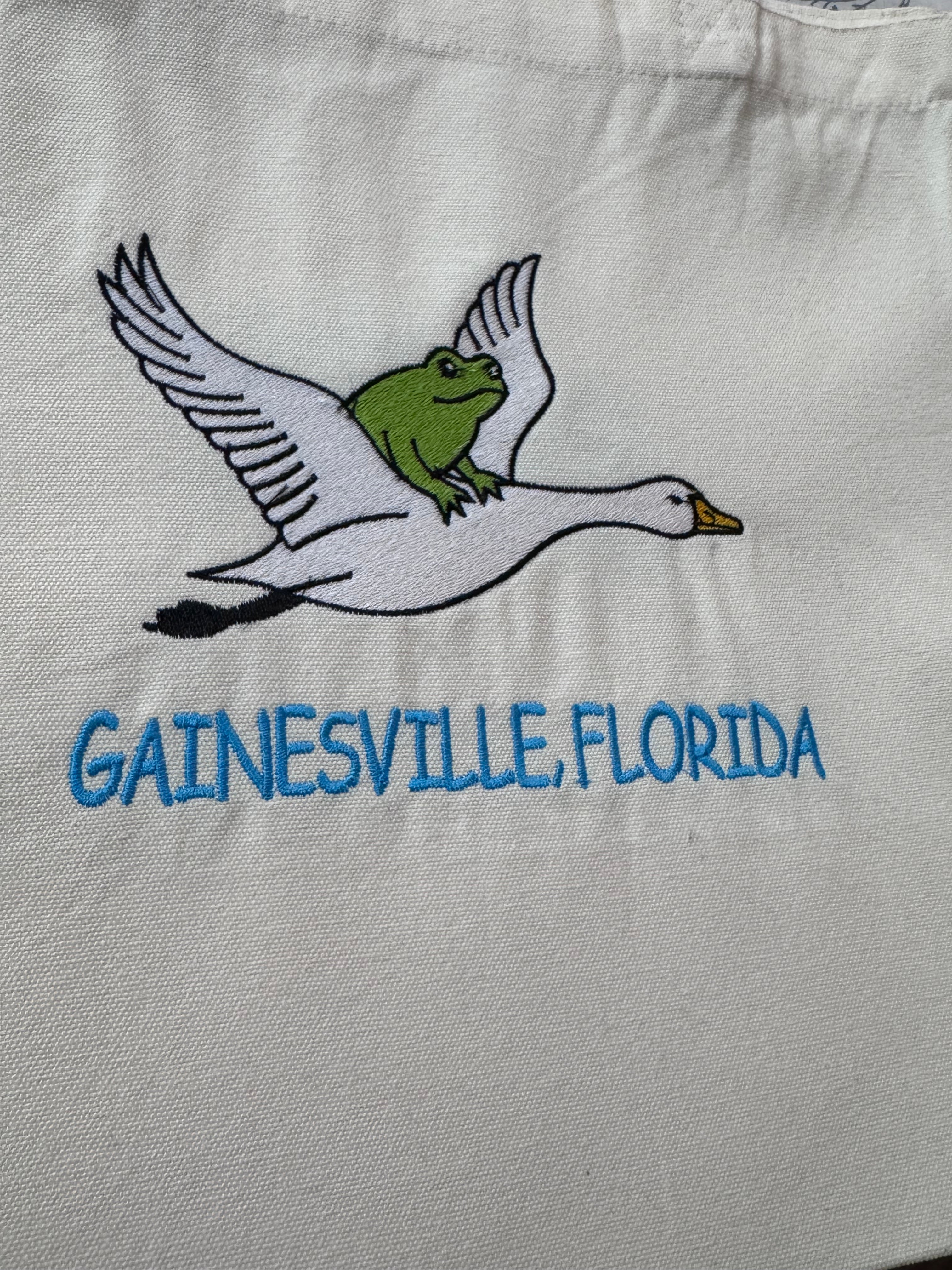 Frog riding on a goose.